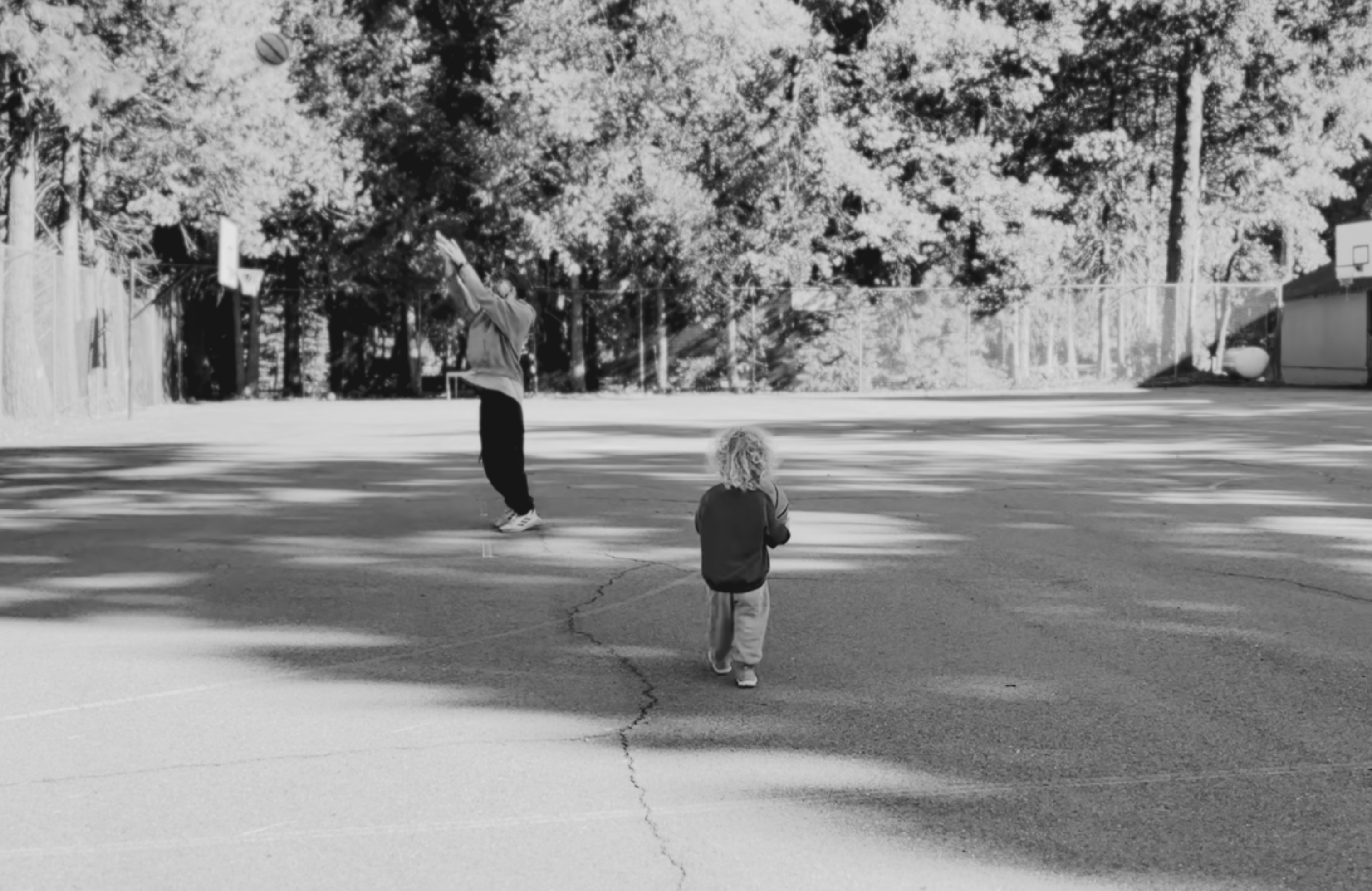 Father and son playing basketball at a retreat center